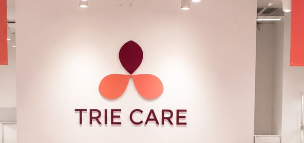 TRIE CARE logo on the store concept brand wall